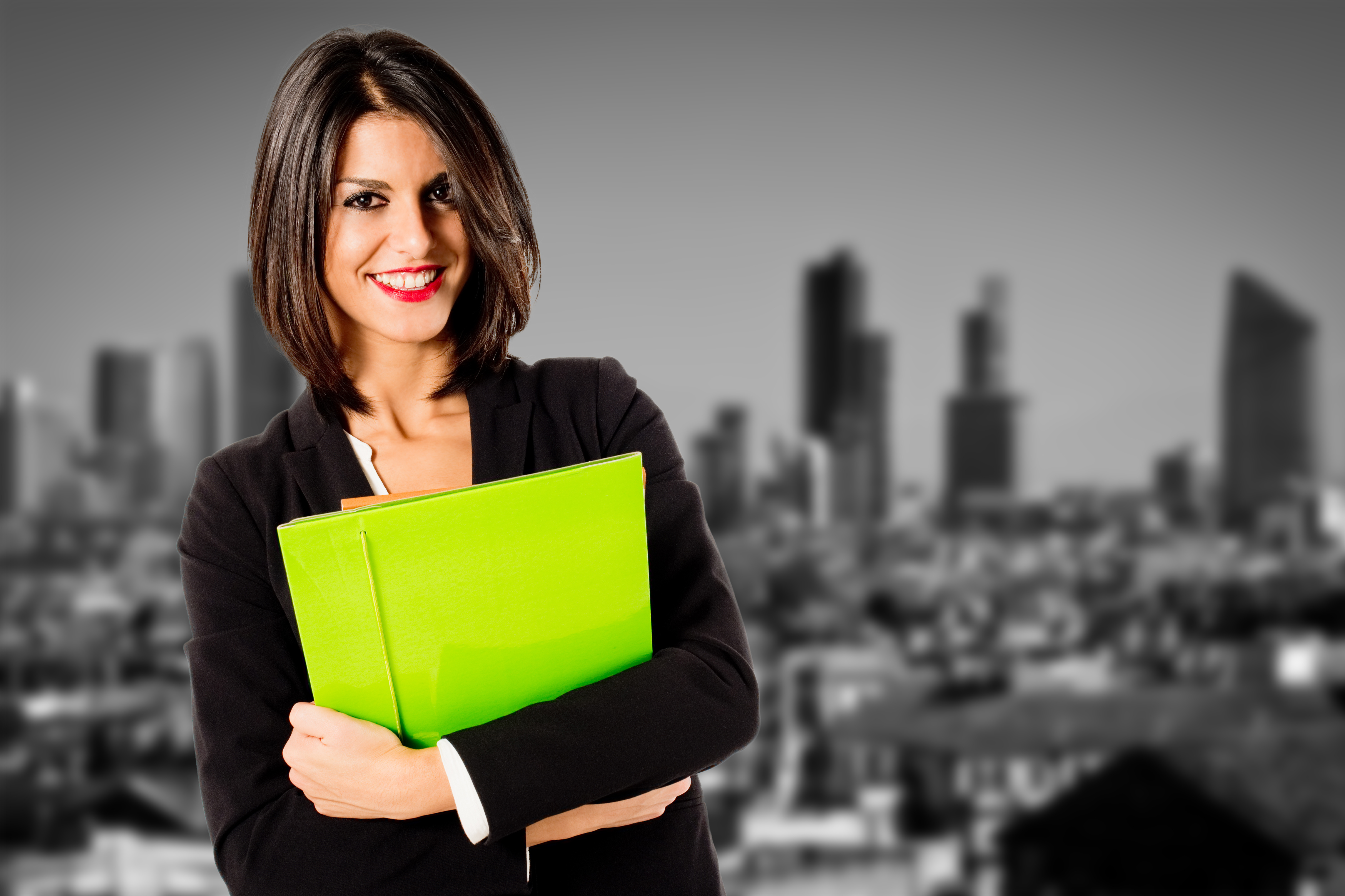 Female real estate agent holding a yellow folder.