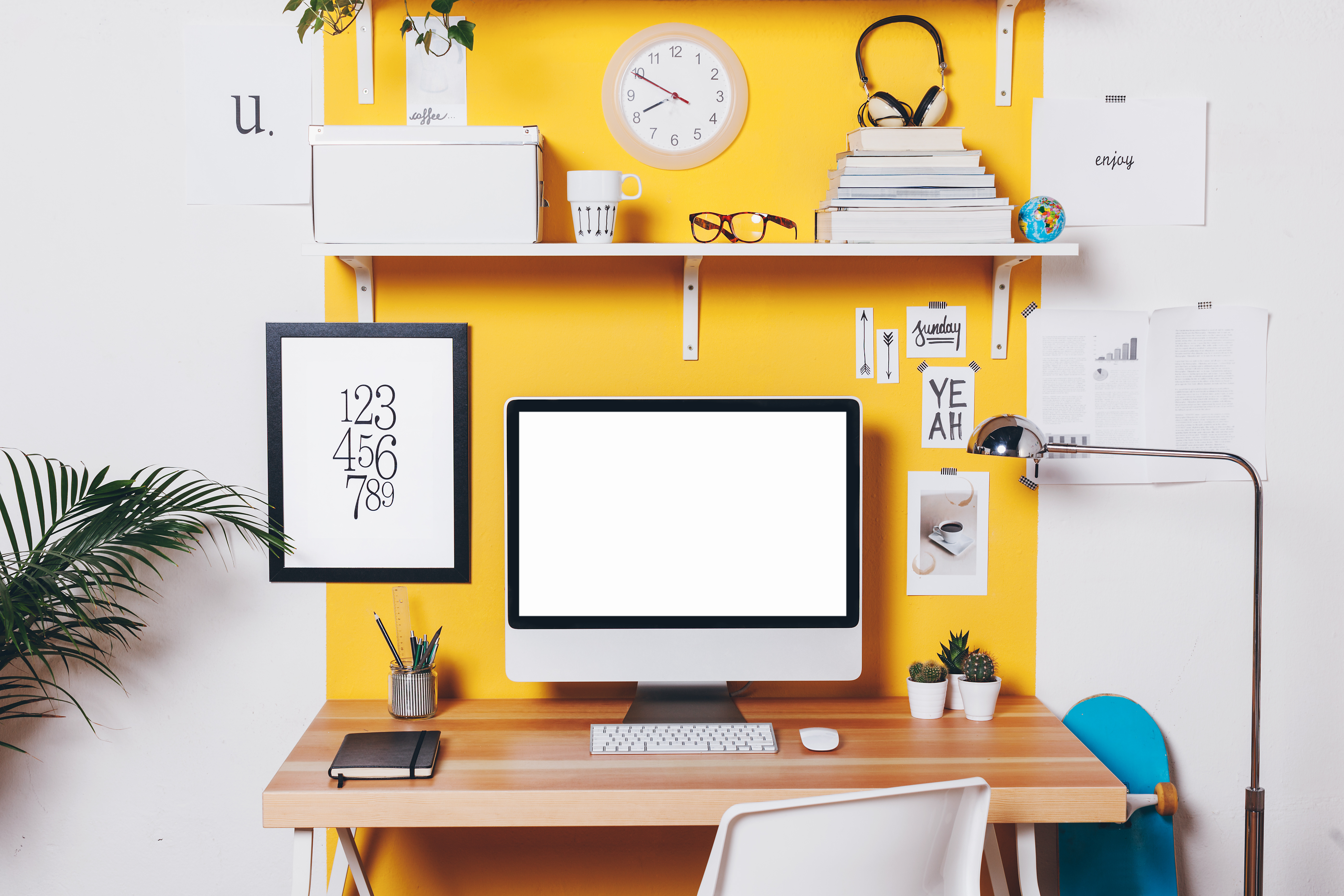 Modern creative workspace on yellow wall. Office workplace with computer.