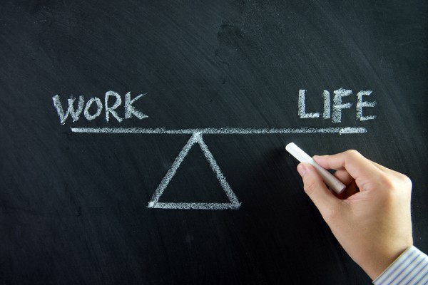 A drawing of a see-saw, with "work" on one side and "life" on another, indicating a work-life balance